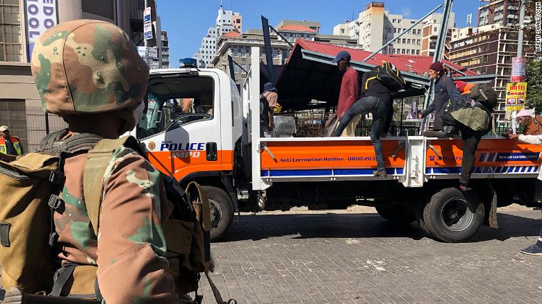 Homeless South Africans in Johannesburg are loaded on the back of a police truck where they were told they would be taken to a shelter to stay during the lockdown.