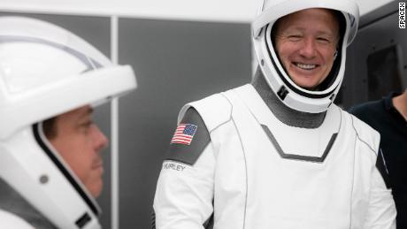 NASA astronauts Bob Behnken (left) and Doug Hurley participate in SpaceX's flight simulator. 