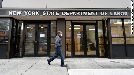 Surge in US unemployment claims cuases Governemnt servers to crash. A man wearing a protective mask walks past the New York State Department of Labor offices in the New York City borough of Brooklyn, NY, March 25, 2020. Anthony Behar/Sipa/Reuters