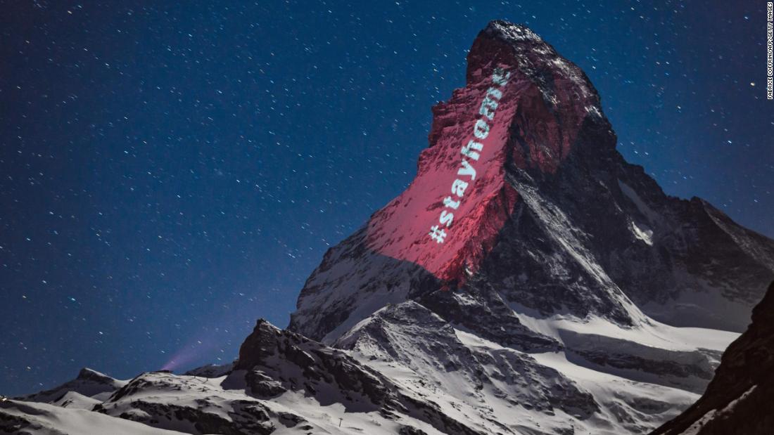 The hashtag &quot;stayhome&quot; is projected onto the Matterhorn mountain that straddles Switzerland and Italy on April 1, 2020. The mountain was illuminated by Swiss artist Gerry Hofstetter, who was transforming buildings, monuments and landscapes all over the world to raise awareness during the pandemic. 