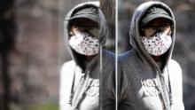 A person wearing protective masks due to coronavirus concerns walks in Philadelphia, Thursday, April 2, 2020. (AP Photo/Matt Rourke)