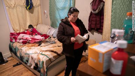 An undocumented Honduran immigrant reads her Bible during self-quarantine with her family for possible COVID-19 on March 30, 2020 in New York. (Photo by John Moore/Getty Images)