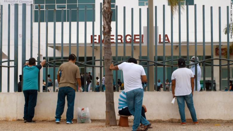 Relatives wait outside of a hospital for information on family members infected with Covid-19 in Guayaquil on April 1.