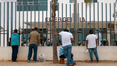 Relatives wait outside of a hospital for information on family members infected with Covid-19 in Guayaquil on April 1.