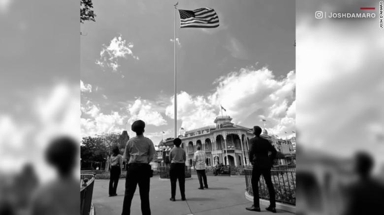 See Disney employees raise American flag in empty park