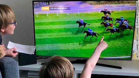 Young fans watch a screening of the Virtual Grand National, which was aired on UK television.