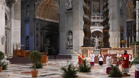 A general view shows Pope Francis (C) holding a palm branch as he celebrates Palm Sunday mass behind closed doors at the Chair of Saint Peter in St. Peter&#39;s Basilica mass on April 5, 2020 in The Vatican, during the lockdown aimed at curbing the spread of the COVID-19 infection, caused by the novel coronavirus. (Photo by Alberto PIZZOLI / POOL / AFP) (Photo by ALBERTO PIZZOLI/POOL/AFP via Getty Images)