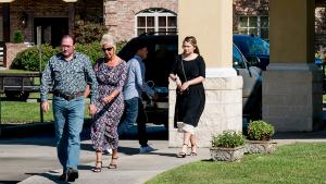 People walk to a Palm Sunday service at Life Tabernacle Church in Baton Rouge, Louisiana on April 5, 2020, despite statewide stay-at-home orders due to the coronavirus, COVID-19, pandemic. - US Surgeon General Jerome Adams said Americans should continue to practice social distancing and stay home for at least 30 days. Adams pleaded with state leaders to urge residents to stay home for at least the next seven to 10 days: "There is a light at the end of the tunnel if everyone does their part." (Photo by Claire BANGSER / AFP) (Photo by CLAIRE BANGSER/AFP via Getty Images)