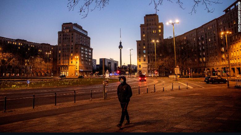  A man with a mask passes by an empty street during the coronavirus crisis in Berlin, Germany. 