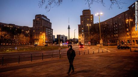 A man walks down an empty street in Berlin.