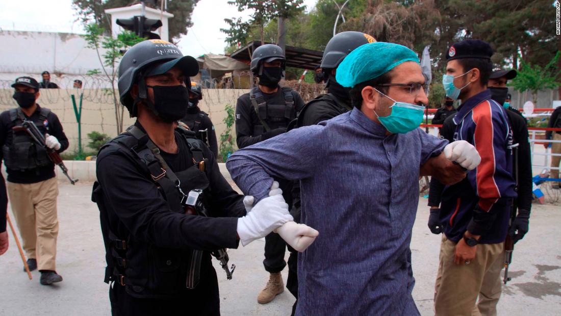 Police detain a doctor in Quetta, Pakistan, who was among dozens of health care workers protesting a lack of personal protective equipment.