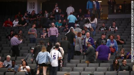 Fans leave the building after the Sacramento King game against the New Orleans Pelicans was postponed due to the coronavirus outbreak.