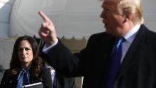 White House Press Secretary Stephanie Grisham (L) listens to U.S. President Donald Trump talk to reporters before he boards Marine One and departing the White House November 08, 2019 in Washington, DC.