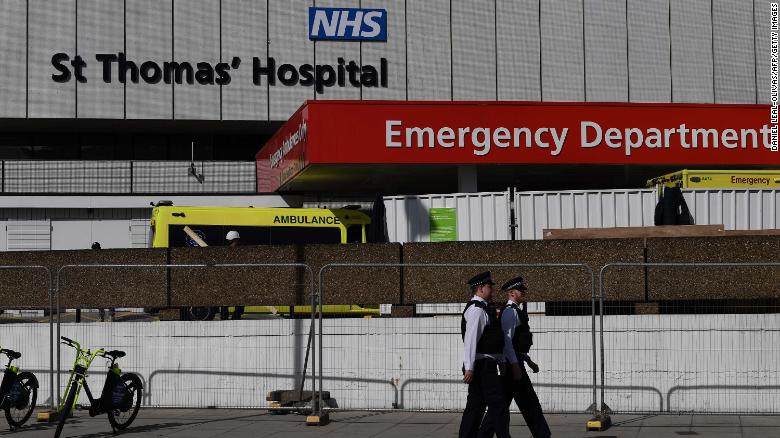 British police officers stand on duty outside St Thomas&#39; Hospital in central London, where Britain&#39;s Prime Minister Boris Johnson is in intensive care on April 7, 2020. 