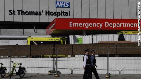 British police officers stand on duty outside St Thomas&#39; Hospital in central London, where Britain&#39;s Prime Minister Boris Johnson is in intensive care on Tuesday, April 7.