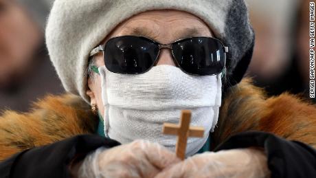 A Christian wearing a facemask amid concerns over the spread of COVID-19.