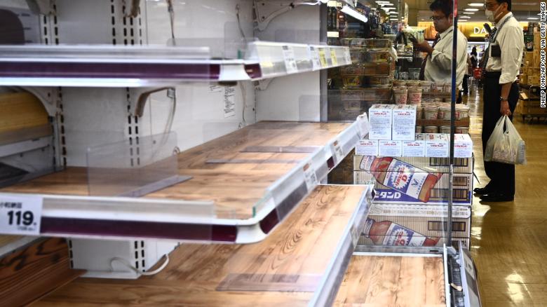 People shop near empty food shelves at a supermarket in Tokyo in April 6, 2020. - Japan's Prime Minister Shinzo Abe said on April 6 the government plans to declare a state of emergency and proposed a stimulus package worth 1 trillion USD as new coronavirus infections spike in Tokyo and elsewhere. (Photo by Philip FONG / AFP) (Photo by PHILIP FONG/AFP via Getty Images)