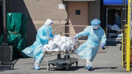 Bodies are moved to a refrigeration truck serving as a temporary morgue at Wyckoff Hospital in Brooklyn on April 6, 2020 in New York. 