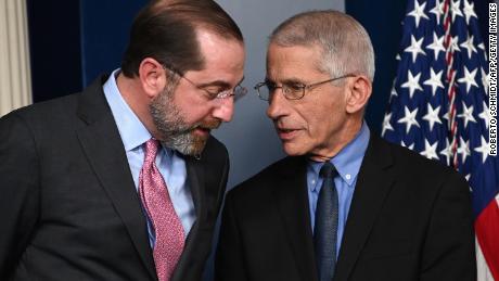 Health and Human Services Secretary Alex Azar (L) and Director of the National Institute of Allergy and Infectious Diseases at the National Institutes of Health Anthony Fauci speak before President Donald Trump arrives for a press conference on the coronavirus.