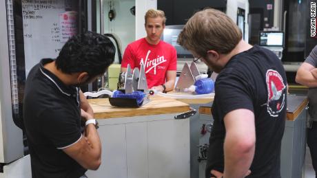 Virgin Orbit engineers (from left to right) Vishal Doshi, Victor Radulescu and Kevin Zagorski, run tests on an early prototype of a bridge ventilator. 