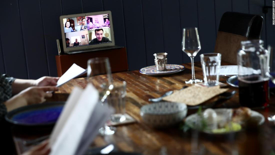 Californians Sarah and Aaron Sanders, along with their children, use video conferencing to celebrate a Passover Seder with other family members.