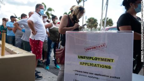 People queue to receive the printed Unemployment Benefits application in the parking lot of Kennedy Library in Hialeah, Florida, USA, 07 April 2020. Hundreds of residents lined up hours before locations were scheduled to open Tuesday across Hialeah, to submit paper applications for unemployment benefits as the state attempts to address problems with its website amid the increased number of applicants during the widespread of the SARS-CoV-2 coronavirus which causes the Covid-19 disease. (Photo by Cristibal Herrera/EPA-EFE/Shutte/Shutterstock)
