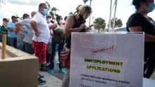 People queue to receive the printed Unemployment Benefits application in the parking lot of Kennedy Library in Hialeah, Florida, USA, 07 April 2020. Hundreds of residents lined up hours before locations were scheduled to open Tuesday across Hialeah, to submit paper applications for unemployment benefits as the state attempts to address problems with its website amid the increased number of applicants during the widespread of the SARS-CoV-2 coronavirus which causes the Covid-19 disease. (Photo by Cristibal Herrera/EPA-EFE/Shutte/Shutterstock)
