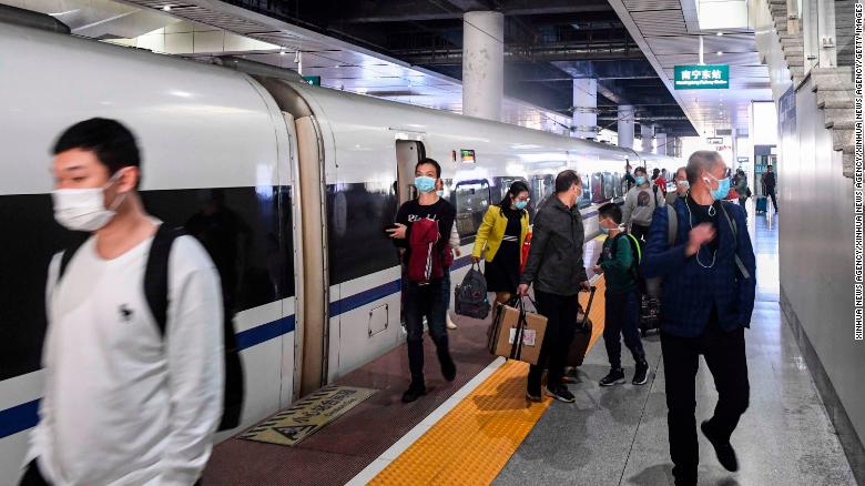 Passengers alight from the first train out of Wuhan in Nanning city, in China's Guangxi region, on Wednesday.