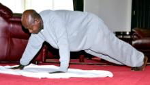 In this handout photo provided by Uganda&#39;s Presidential Press Unit, Uganda&#39;s President Yoweri Museveni performs push-ups in a video released to the public via the president&#39;s social media accounts, at State House in Entebbe, Uganda Thursday, April 9, 2020. Uganda&#39;s 75-year-old president has released a homemade exercise video to show skeptical countrymen that one can stay in shape under the lockdown that has been implemented to curb transmission of the new coronavirus. (Uganda Presidential Press Unit via AP)
