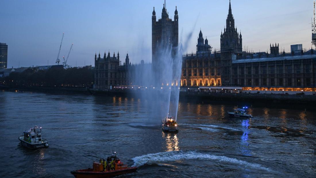 Service boats spray water in London to show support for health care workers on April 9, 2020.