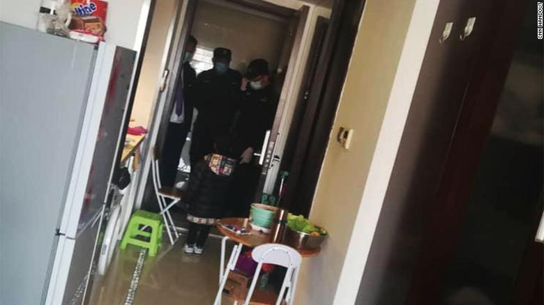 Police come to the house of an African resident in Beijing.