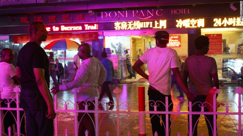 Africans stand in front of the Don Franc hotel in Guangzhou, before the coronavirus crisis.