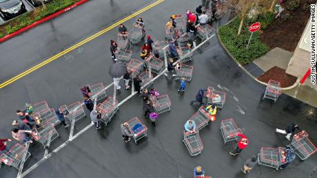 Hundreds of people line up to enter a Costco store in California. 