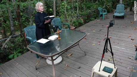 Rev. Jo-Ann Murphy, assistant rector of St. Stephen&#39;s Episcopal Church, live streams a Good Friday Mass from her backyard during the new coronavirus pandemic.