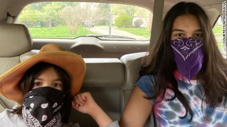 My masked daughters, 8 and 15, prepared for an outing.