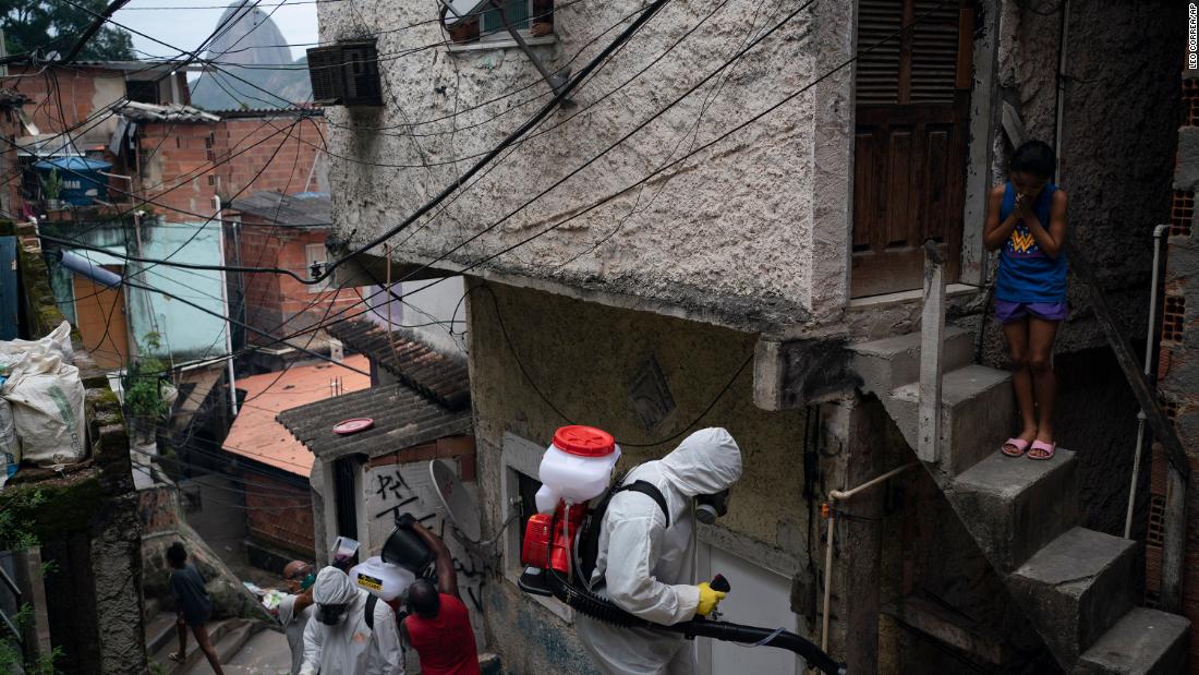 Volunteers spray disinfectant in a favela in Rio de Janeiro.