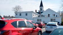 Pastor Aaron R. Goodro, 46, (center) speaks and plays music to his parishioners with Justin Knowlton and Felicia Berry from the rooftop of his church during a drive-in Easter Service at the First Baptist Church in Plaistow, New Hampshire on April 12, 2020. - Since the Covid-19 pandemic has made services inside the church a danger to health, the church has started to hold gatherings in its parking lot with parishioners listing to the service over a loud speaker system and soon a FM radio station. (Photo by Joseph Prezioso / AFP) (Photo by JOSEPH PREZIOSO/AFP via Getty Images)