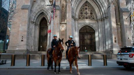 New York City Police officers patrol outside the St. Patrick&apos;s Cathedral.