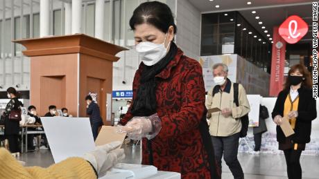 A South Korean woman casts a ballot during early voting at a polling station in Seoul on April 10.
