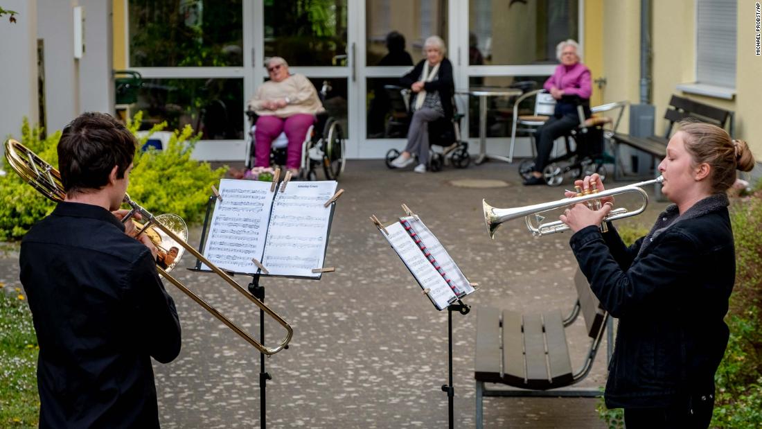 Musicians play their instruments for a retirement home in Karben, Germany.