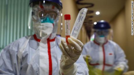 This photo taken on February 4, 2020 shows a medical staff member showing a test tube after taking samples taken from a person to be tested for the new coronavirus at a quarantine zone in Wuhan, the epicentre of the outbreak, in China&#39;s central Hubei province. - The world has a &quot;window of opportunity&quot; to halt the spread of a deadly new virus, global health experts said, as the number of people infected in China jumped to 24,000 and millions more were ordered to stay indoors. (Photo by STR / AFP) / China OUT (Photo by STR/AFP via Getty Images)