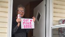 The 93-year-old stands on her porch with her Coors Light delivery.
