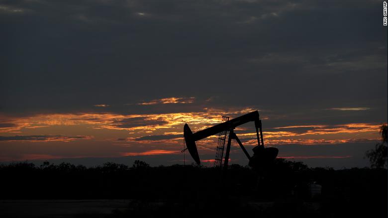 The sun sets behind an idle pump jack near Karnes City, Texas, Wednesday, April 8, 2020. Demand for oil continues to fall due to the new coronavirus outbreak. (AP Photo/Eric Gay)