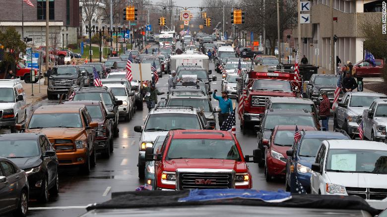 Vehicles sit in gridlock during a protest in Lansing, Mich., Wednesday, April 15, 2020. Flag-waving, honking protesters drove past the Michigan Capitol on Wednesday to show their displeasure with Gov. Gretchen Whitmer&#39;s orders to keep people at home and businesses locked during the new coronavirus COVID-19 outbreak. 