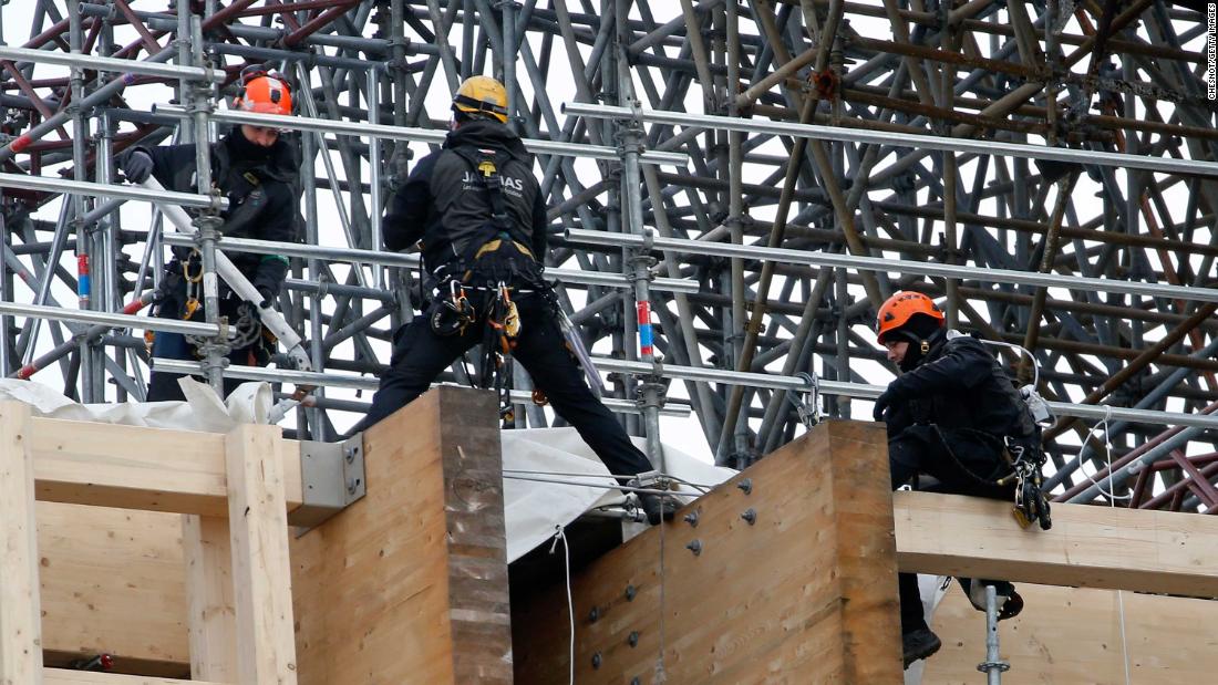 Professional mountain climbers work on a part of the Notre Dame Cathedral restoration on January 29.