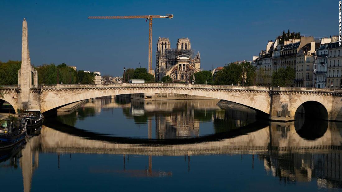 Notre Dame and the Pont de la Tournelle bridge are reflected in the Seine river on Easter Sunday, April 12.