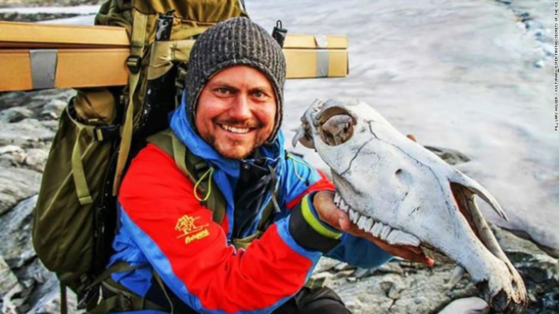 Researcher Elling Utvik Wammer holds the skull of an unlucky packhorse that did not survive its journey. The skull was dated to 1700 AD, making it the most recent item found at the site.