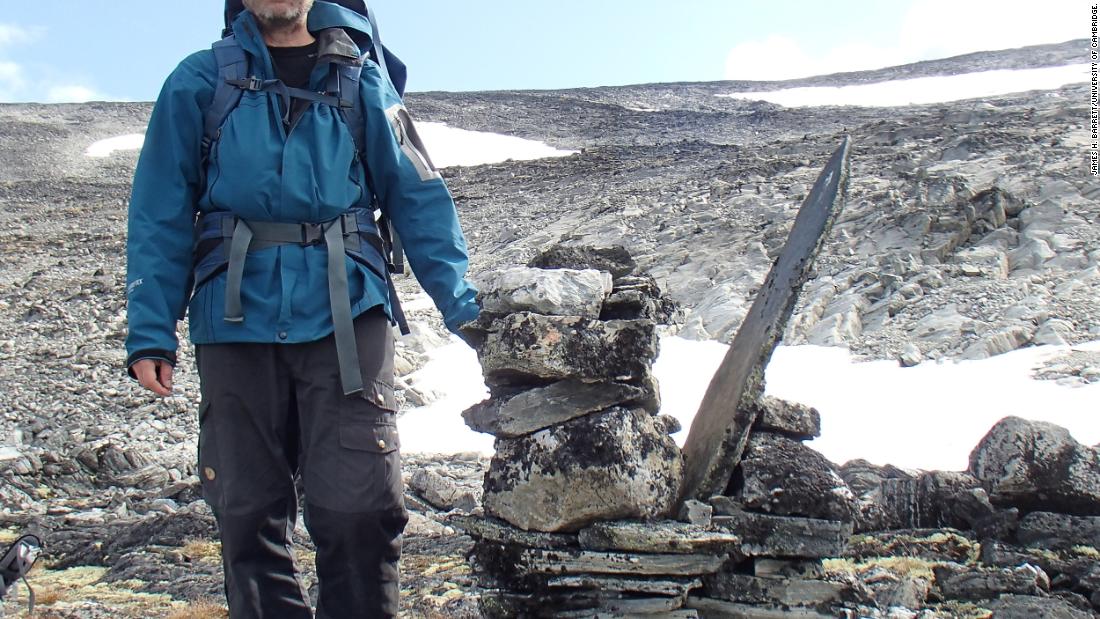 Researcher Lars Pilø is pictured by a cairn, which was used to mark the route of the mountain pass. 