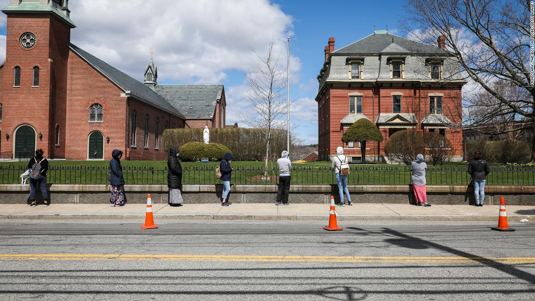 People line up for food assistance in Waltham, Massachusetts, in April.