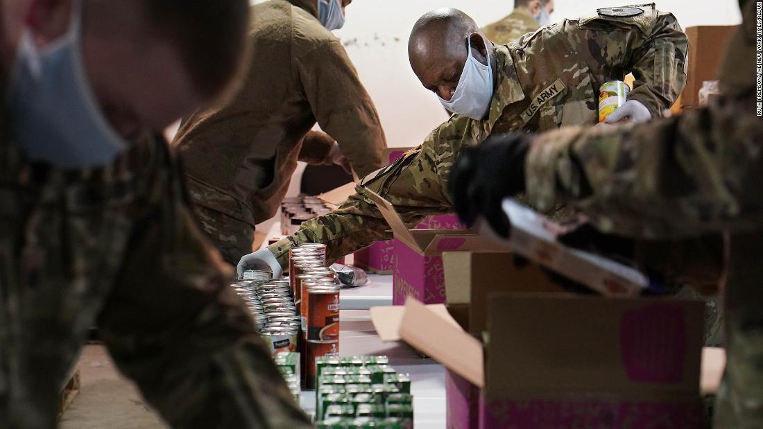National Guard members help pack food boxes at the Nourish Pierce County food bank in Tacoma, Washington.